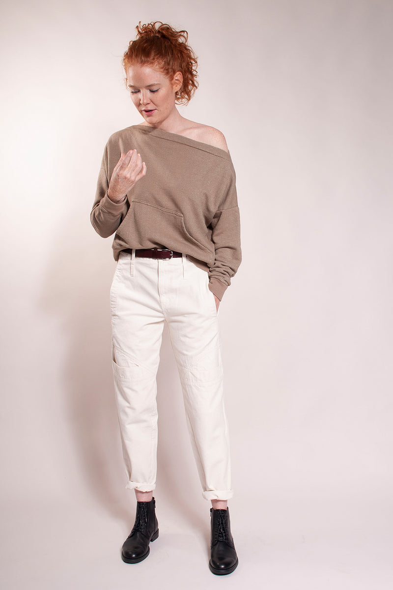 Updated 80's fit with high waist and tapered ankle. Front pockets at hip and knee detail. Back patch pockets and double rows of belt carriers.  Pre-shrunk acid washed super soft 100% cotton canvas. Model is wearing size 27.  Inseam is 27".